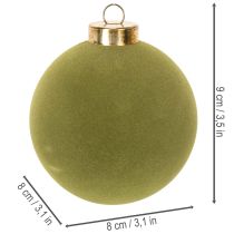 Article Boule de Noël effet velours, verte, texture variée, 8 cm, lot de 12. Boule de Noël floquée vert mousse, en plastique. Cordon en coton inclus.