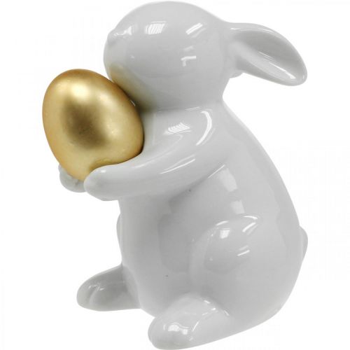 Floristik24 Lapin avec oeuf doré en céramique, décoration de Pâques blanc élégant, doré H15cm