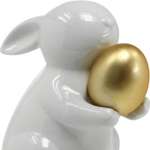 Floristik24 Lapin avec oeuf doré en céramique, décoration de Pâques blanc élégant, doré H15cm
