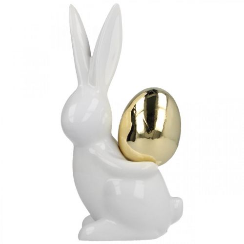Floristik24 Lapins de Pâques élégants, lapins en céramique avec oeuf doré, décoration de Pâques blanc, doré H18cm 2pcs