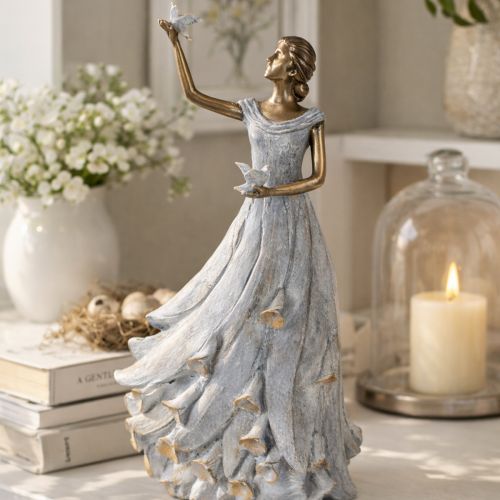 Article Figurine représentant une femme avec un oiseau. Sculpture décorative au design intemporel et raffiné. 41 cm